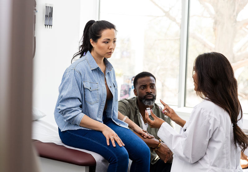 Doctor-explaining-medical-treatment-to-a-couple-2220760737 Doctor explaining medical treatment to a couple